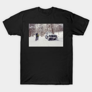 Tourist walking alone through winter forest passing off-road parked car T-Shirt